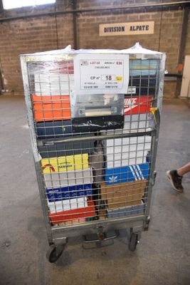 a metal cart with several boxes on it in a warehouse