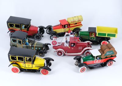 a lot of toy cars that are sitting on a white surface