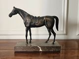 a statue of a horse that is standing on a table