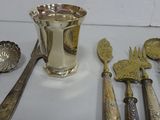 a lot of silver spoons and utensils on the table