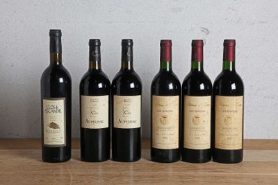 six bottles of wine are lined up on a wooden table