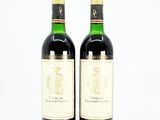 two bottles of wine sitting next to each other on a table