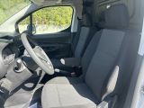 the interior of a small van with a steering wheel and seat covers