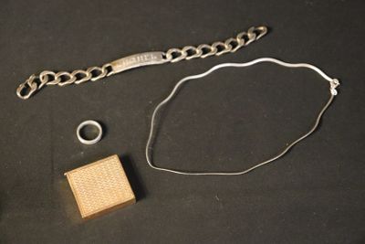 a bracelet, ring, and bracelet chain on a table