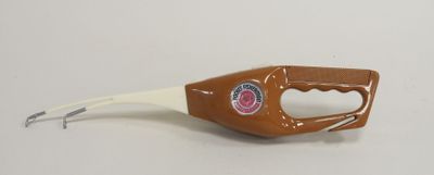 a bottle opener with a handle on a white surface