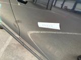 a sticker on the door of a car that is parked in a parking lot