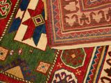 some very colorful rugs are laying on a white surface