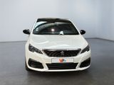 the front of a white car is parked in a white room