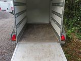a white trailer that is parked on the side of the road