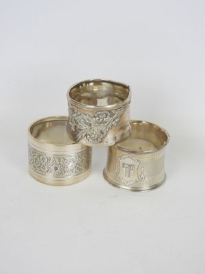trois serviettes argentées ornées de motifs sur fond blanc