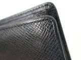 a close up of a black leather wallet with a zipper