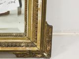 an image of a gold framed mirror with writing on it