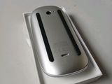 a silver cell phone in a white box on a table