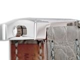 a close up of a watch with a leather strap