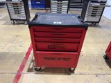 red and black tool cabinet with wheels and drawers in a garage