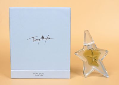 a close up of a perfume bottle next to a box