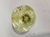 a green substance in the middle of a white bowl