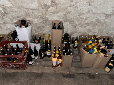 many bottles of wine sitting on the floor next to each other