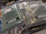 two pillows that are wrapped in plastic bags on a table