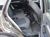 the back seat of a car with the door open in a parking lot
