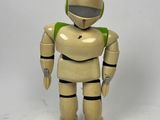 a toy robot that is standing on a white surface