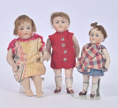 three dolls that are standing next to each other