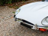 a white sports car parked in a parking lot
