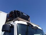 a white truck with a box on top of it