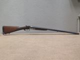 the rifle is laying on the table next to the wall