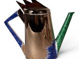 a metal watering can with a blue and green design on it