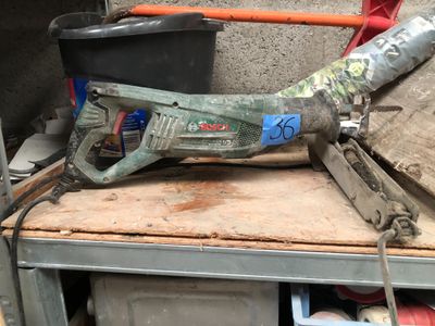 a drill that is sitting on top of a workbench