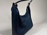 navy blue leather handbag on a white background