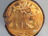 an image of a gold plate with an image of a man and a woman on it