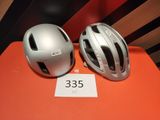 two helmets are sitting on a table next to each other