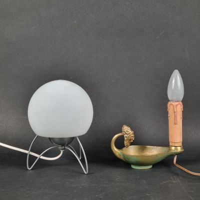 three different types of lamps on a black surface with a gray background