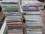many dvds stacked on top of each other on the floor