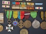 an assortment of medals and medals are displayed on a black surface