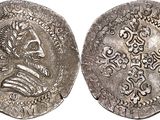 a silver coin with an image of a man on it