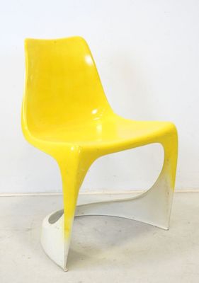 a yellow chair that is sitting in a room