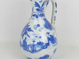 a blue and white vase with a bird design on it