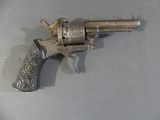 a silver revolver on a table with a black handle