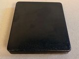 an open black leather wallet sitting on top of a white table