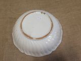 a white bowl with a brown rim sitting on a table