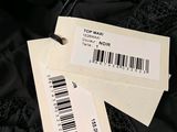 two tags on a black jacket with a barcode on it