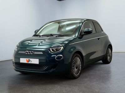 the small car is parked in a large room with white walls
