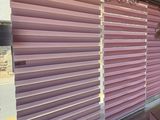 purple blinds in a room with wooden floors and a large window