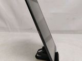 the tablet is sitting on a stand on a white surface