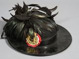 a black hat with a gold crown on top of it