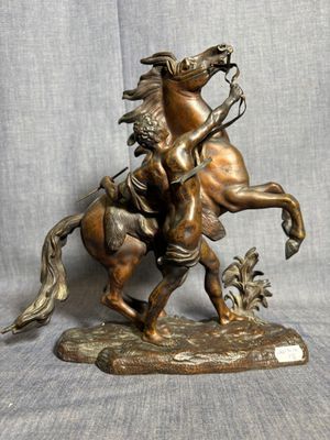 statue en bronze représentant un homme à cheval tenant un oiseau dans la main