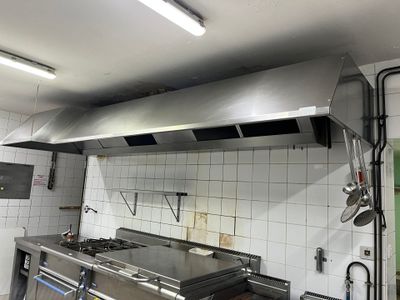 a kitchen with a stove, oven, and sink in it